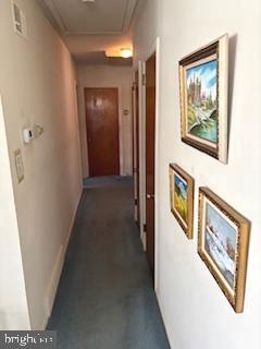 corridor featuring baseboards