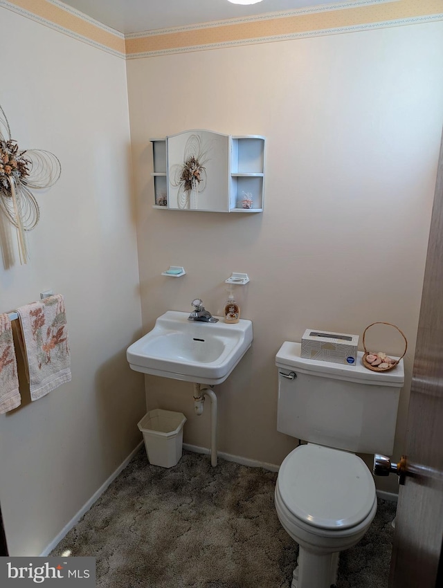 bathroom with baseboards and toilet