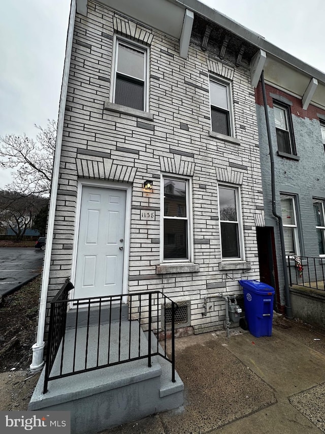 rear view of house with brick siding