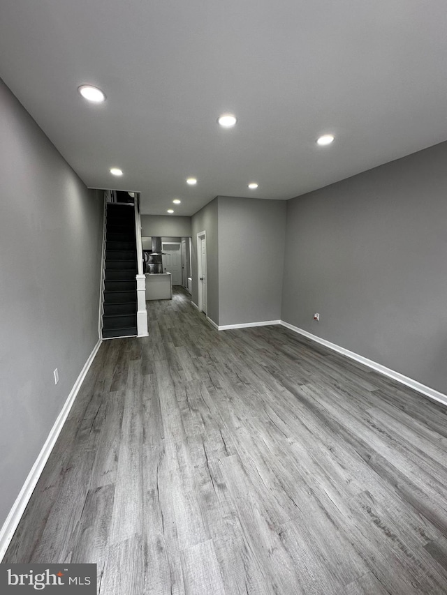 interior space featuring dark wood-style flooring, stairway, recessed lighting, and baseboards