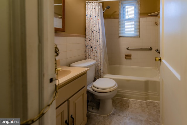 full bathroom with toilet, vanity, tile walls, tile patterned floors, and shower / bath combo with shower curtain