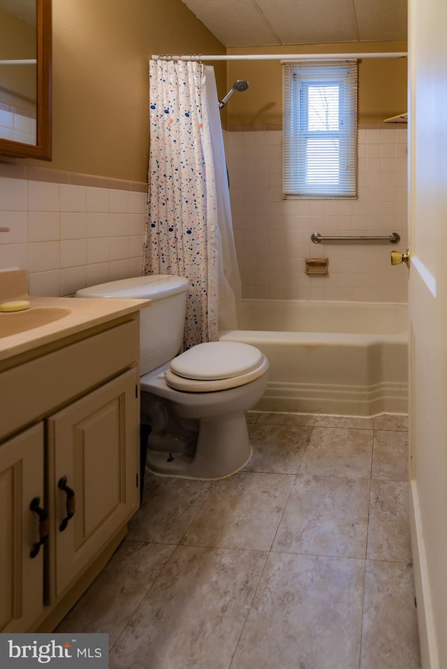 bathroom with toilet, shower / tub combo, vanity, tile walls, and tile patterned floors