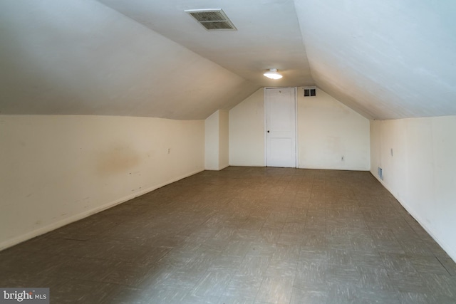 bonus room featuring lofted ceiling and visible vents