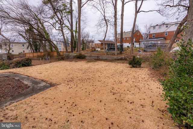 view of yard featuring a residential view and fence