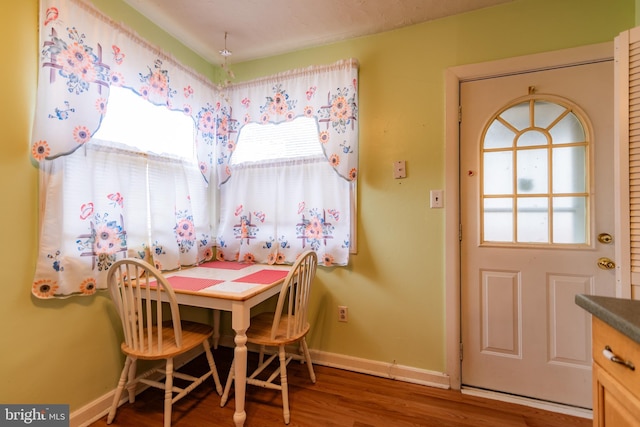 dining area featuring baseboards and wood finished floors