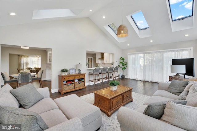 living area featuring a skylight, plenty of natural light, wood finished floors, and recessed lighting