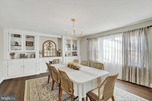 dining room featuring dark wood finished floors and a notable chandelier