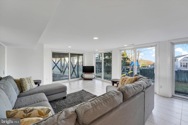 living area featuring light tile patterned floors and recessed lighting