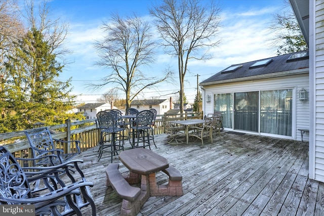 wooden deck featuring outdoor dining area