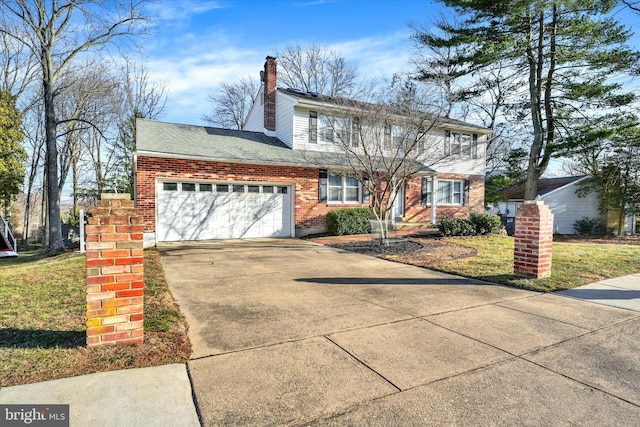 view of front of house featuring brick siding, a front lawn, a chimney, a garage, and driveway