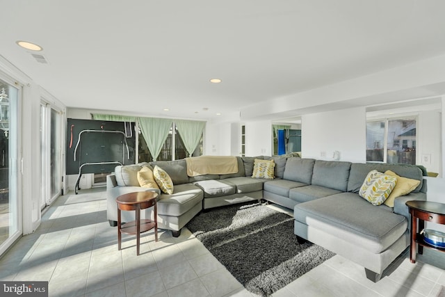 living room with light tile patterned floors, visible vents, and recessed lighting