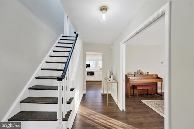 stairs with wood finished floors and baseboards