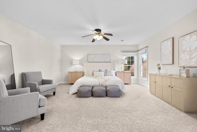 bedroom with light carpet, ceiling fan, and baseboards