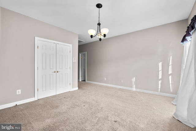 interior space featuring baseboards and an inviting chandelier