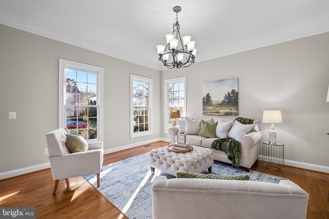 living area with ornamental molding, a wealth of natural light, and wood finished floors