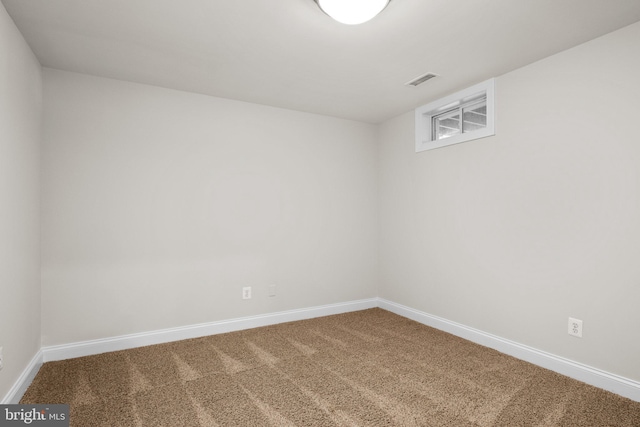 carpeted empty room featuring visible vents and baseboards