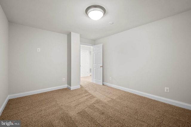 unfurnished bedroom with carpet floors and baseboards