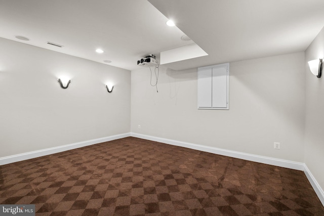 finished below grade area with recessed lighting, dark carpet, visible vents, and baseboards