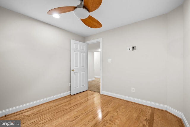 empty room featuring ceiling fan, wood finished floors, and baseboards