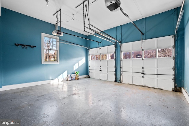 garage featuring a garage door opener and baseboards