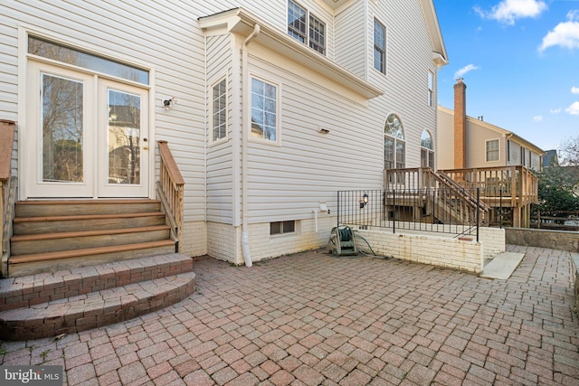 entrance to property with a patio area and a wooden deck