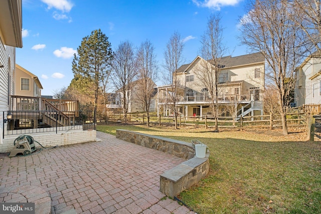 exterior space featuring a patio, fence, stairway, a wooden deck, and a residential view