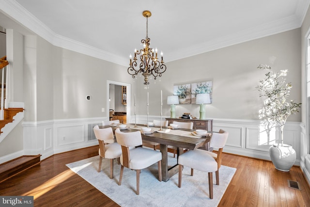 dining room with light wood finished floors, stairs, visible vents, and an inviting chandelier