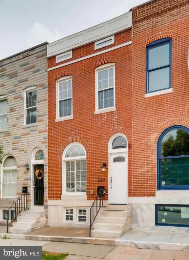 view of property with brick siding