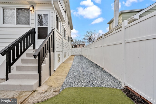 view of property exterior featuring a gate and fence