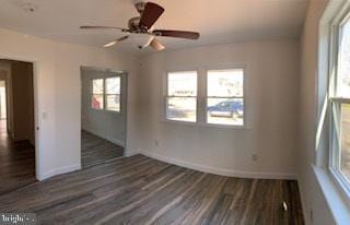 unfurnished room with baseboards, wood finished floors, and a ceiling fan