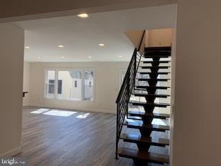 staircase with recessed lighting, baseboards, and wood finished floors