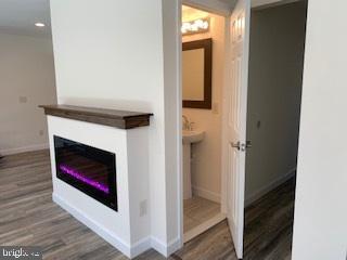 bathroom with recessed lighting, baseboards, and wood finished floors