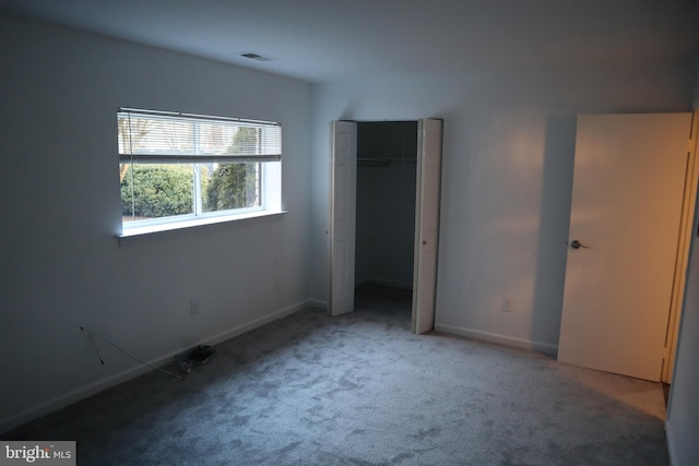 unfurnished bedroom featuring visible vents, baseboards, a closet, and carpet flooring