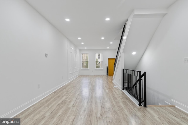 interior space featuring light wood finished floors and baseboards