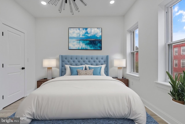 bedroom with light wood-style floors, baseboards, and recessed lighting