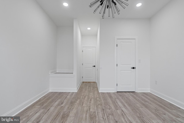 spare room with light wood-type flooring, baseboards, and recessed lighting