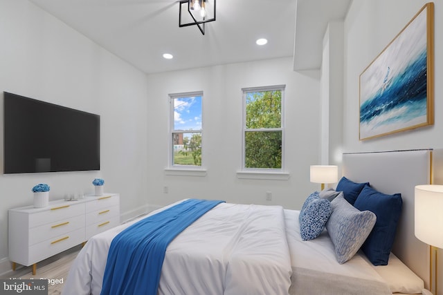 bedroom with baseboards, recessed lighting, and light wood-style floors