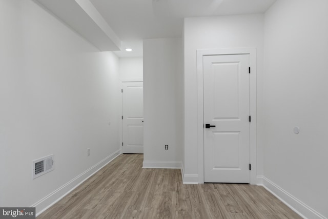 interior space featuring light wood-style flooring, recessed lighting, visible vents, and baseboards