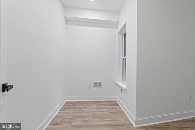 interior space with light wood finished floors, visible vents, and baseboards