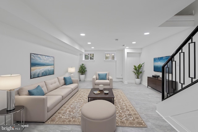 living room with recessed lighting, stairway, and baseboards