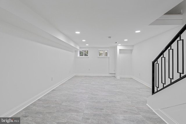 below grade area with stairs, baseboards, and recessed lighting