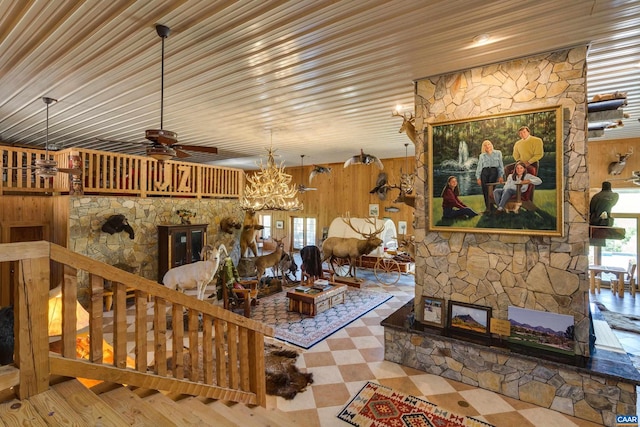 240 Stoneleigh Rd, Palmyra, VA 22963 - living room with a chandelier, ceiling fan, and wooden walls