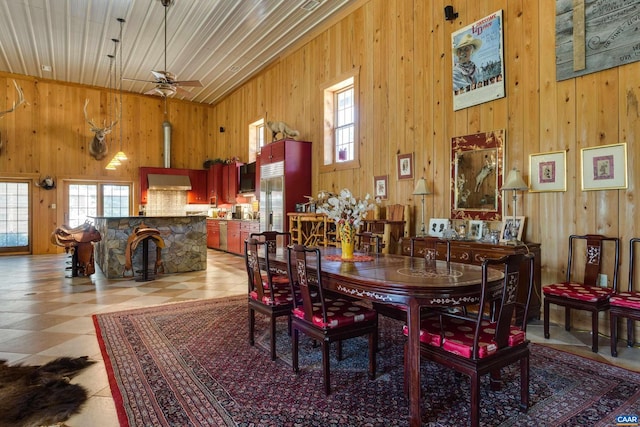 240 Stoneleigh Rd, Palmyra, VA 22963 - dining room with plenty of natural light, wooden walls, vaulted ceiling, light floors, and ceiling fan