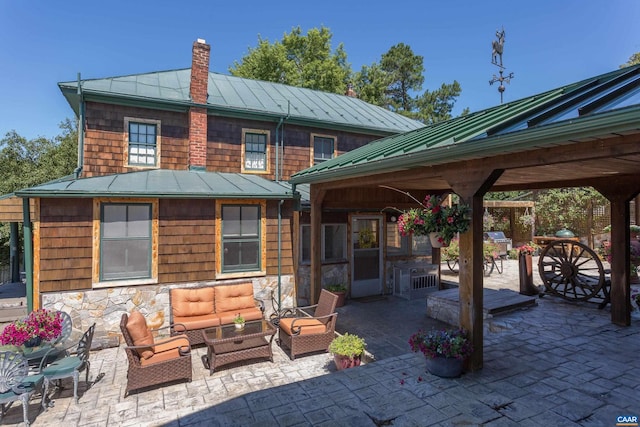 240 Stoneleigh Rd, Palmyra, VA 22963 - back of property with a standing seam roof, outdoor lounge area, a gazebo, a chimney, and a patio