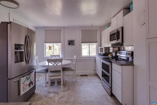 240 Stoneleigh Rd, Palmyra, VA 22963 - kitchen featuring stainless steel appliances, plenty of natural light, white cabinetry, and dark countertops