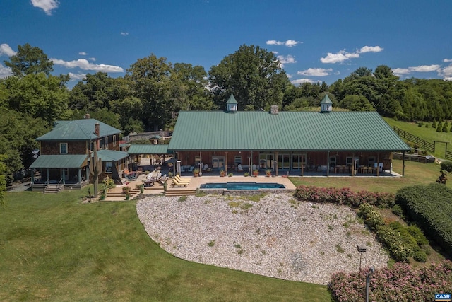 240 Stoneleigh Rd, Palmyra, VA 22963 - back of house featuring an outdoor pool, a lawn, metal roof, and a patio area