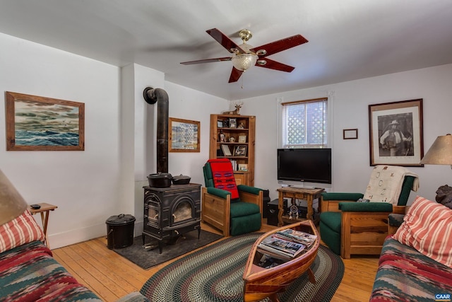240 Stoneleigh Rd, Palmyra, VA 22963 - living area featuring a wood stove, ceiling fan, light wood-style flooring, and baseboards