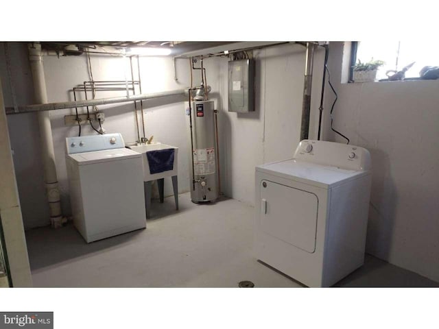 washroom featuring laundry area, electric panel, washer and clothes dryer, and gas water heater