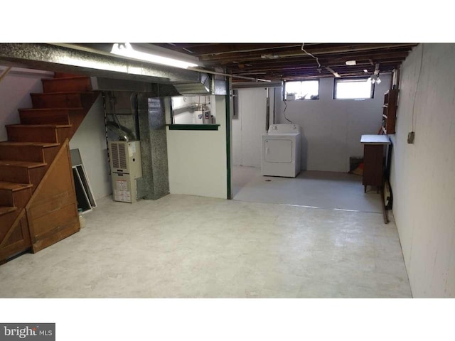 basement with stairs, washer / dryer, and heating unit