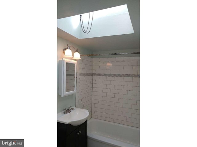 bathroom featuring bathtub / shower combination and vanity